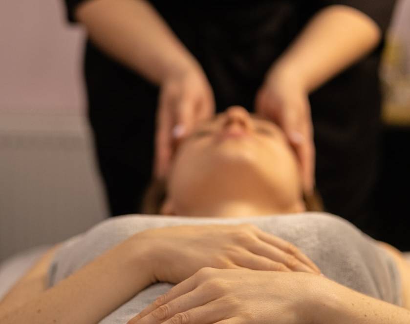 a woman getting a facial massage at a spa